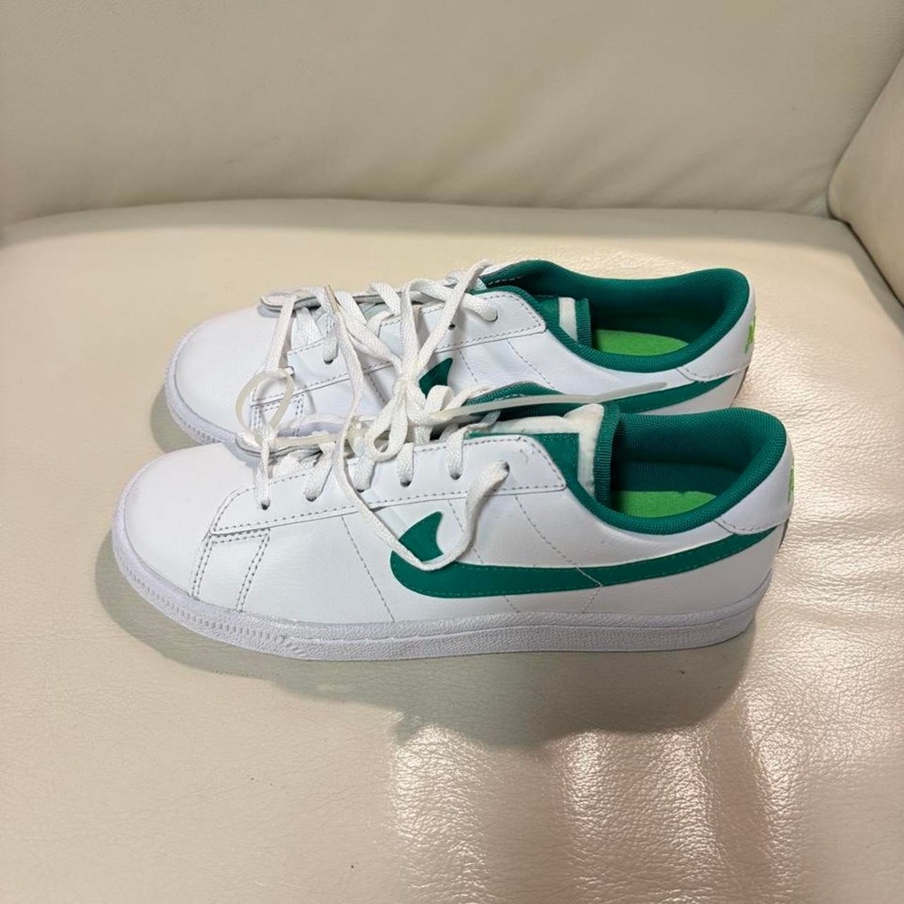 Nike Tennis Classic sneakers in white with green Nike swoosh